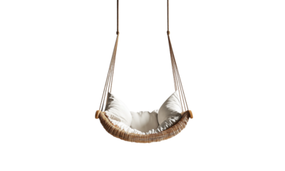 Woven rattan hanging swing chair with plush white cushions suspended by sturdy ropes.