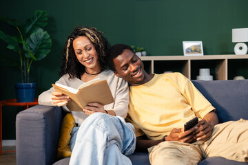 Smiling diverse couple enjoying leisure time together at home