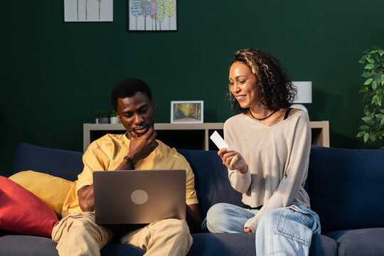 Couple online shopping using laptop and credit card