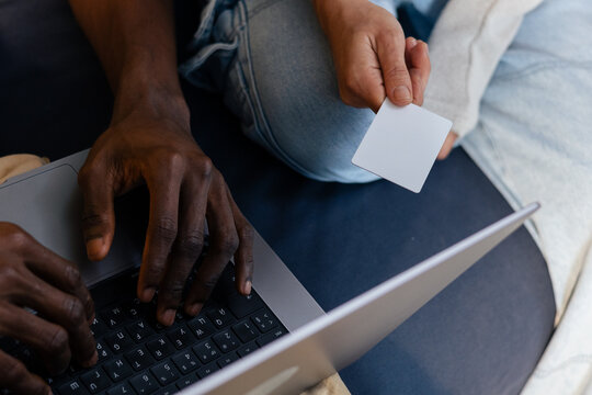 Couple hands holding credit card using laptop shopping online