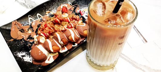 A tasty pancake with chocolate and fresh strawberries slices