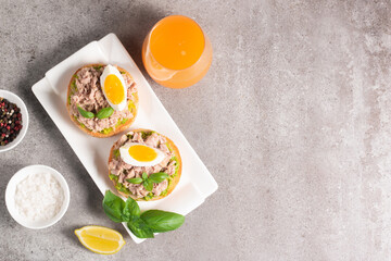 Two delicious tuna open sandwiches with avocado and boiled eggs. Tuna toast.