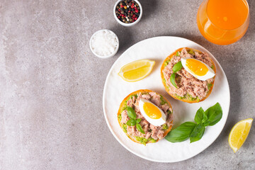 Two delicious tuna open sandwiches with avocado and boiled eggs. Tuna toast.
