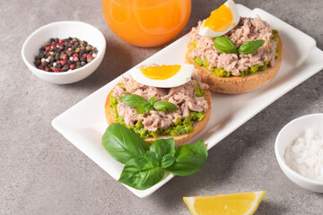 Two delicious tuna open sandwiches with avocado and boiled eggs. Tuna toast.