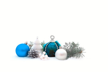 Christmas decorations and fir branches in fluffy snow. Copy space