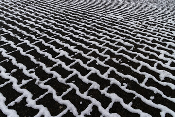 Patterned Snow on a Ground with Bone Stones Creating a Geometric Design