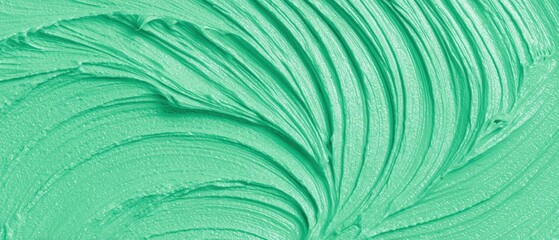 Fototapeta premium Close-up of vivid green textured paint stroke with intricate swirling patterns and glossy smooth finish for creative design purposes
