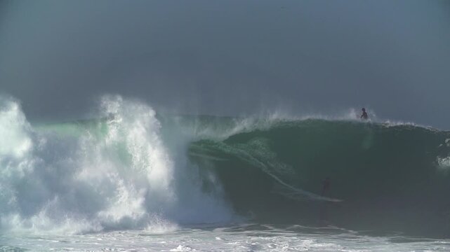Surfer getting a full barrel wave