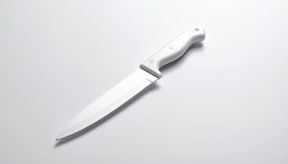 White-handled kitchen knife laying diagonally on a white surface