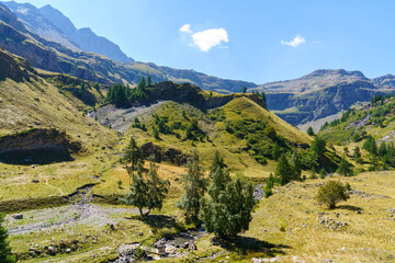 Sunlit mountain valley with a winding stream