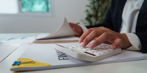 Financial Management. Professional calculating financial data while reviewing documents.
