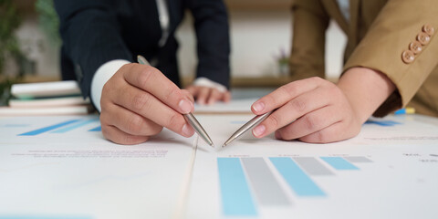 Business Collaboration. Professionals analyzing financial reports and graphs together.