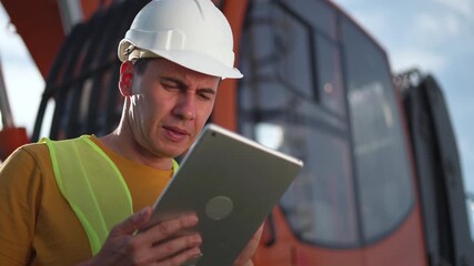 Inspector checks heavy equipment with tablet while construction worker in helmet and reflective vest conducts inspection near orange crane cabin showing safety focus and engineer overseeing site - Powered by Adobe