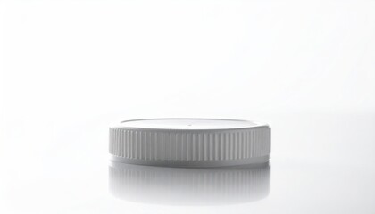 White ribbed plastic cap, minimalist on glossy surface