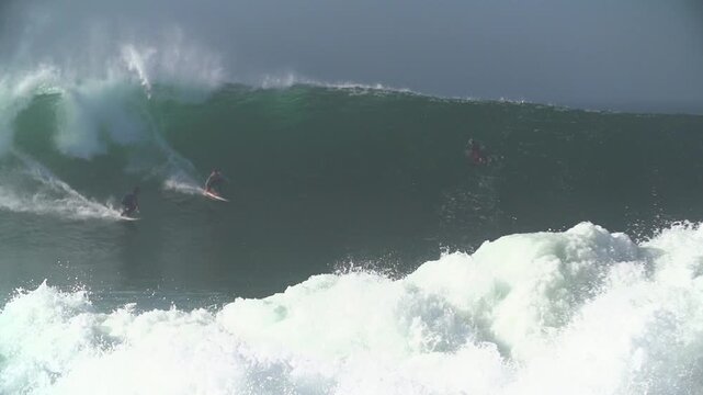 Surfer getting a full over head barrel wave