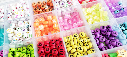 Bracelets with plastic beads. Cute children's accessories, letters and charms in the shape of hearts or flowers. Handmade Friendship Bracelets. Line vector illustration isolated on background