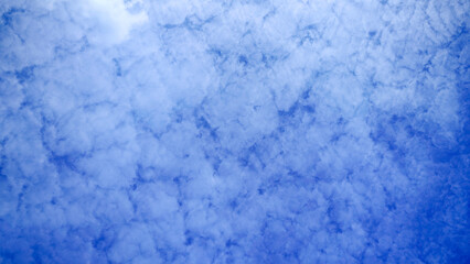Vast Blue Sky Background Filled with Dense Altocumulus Clouds: Beautiful Weather, Freedom, and Natural Atmospheric Texture