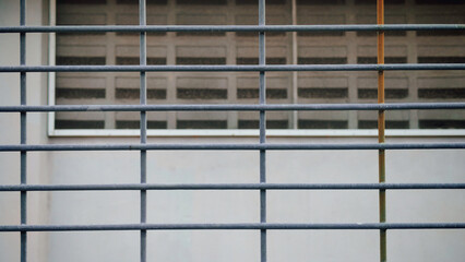 Window Security Grille and Concrete Vent Blocks: Urban Architecture Detail Representing Protection, Restriction, and Modern Minimalist Design