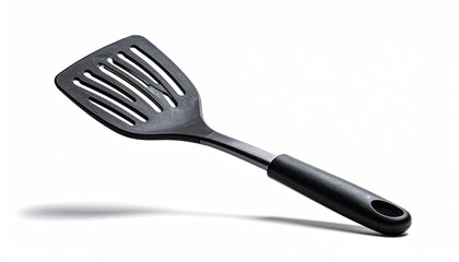 Slotted black spatula angled on white