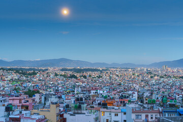 Cityscape under a full moon