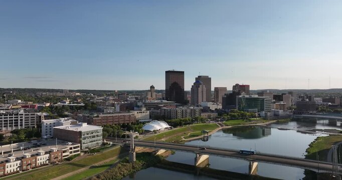 Aerial view of the reflective river winding past the Dayton skyline and road bridge, contrasting with the buildings, Dayton, Ohio, United States.