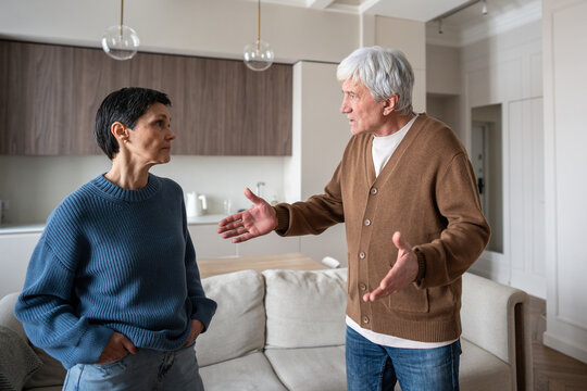 Irritated husband wife arguing, man waving arms during conflict. Relationship problem, marital argument, couple conflict, anger issue, domestic dispute and communication breakdown, emotional tension - Powered by Adobe