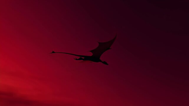 An intense crimson sunset over expansive silhouettes of mountains with a soaring bird