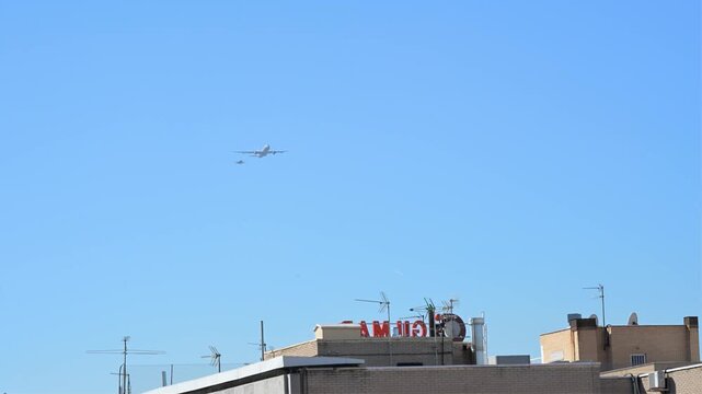 A Spanish Air Force A330 MRTT tanker and F A-18 Hornet fly over Madrid. The aircraft perform during the National Day military parade, a tribute to the flag and Spain's Armed Forces.