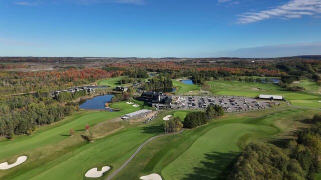 The drone flies high over the TPC Toronto clubhouse, revealing the scale of the facility, the beautiful water hazards, and the rolling autumn landscape of Ontario.