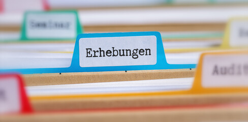 File folders with a tab labeled Suveys in german - Erhebungen