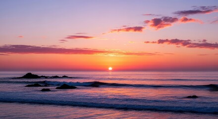 Fototapeta premium A breathtaking sunset over the ocean, with vibrant colors painting the sky and gentle waves lapping the shore