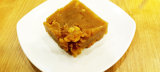flour halva with hazelnuts on a white plate