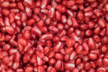 Fresh, vibrant, and juicy pomegranate seeds, perfectly arranged to create a natural and eye-catching texture. Ideal for food photography, design, decorative backgrounds, advertising, and packaging.