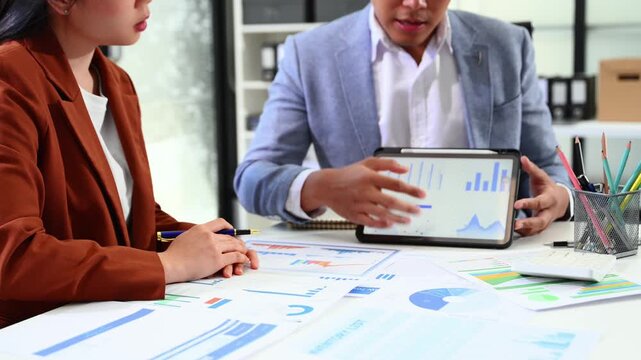 Businessman and team analyzing financial statement Finance task. with smart phone and laptop and tablet. Wealth management concept