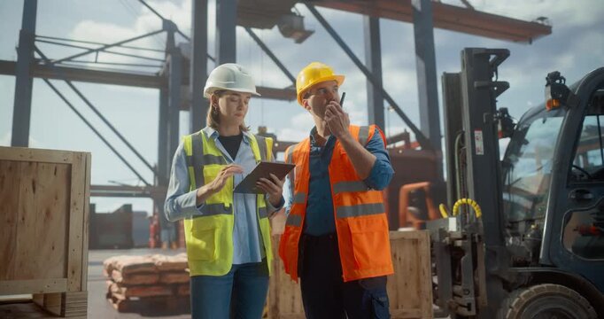 Dock Worker and Tally Clerk Manage Port Logistics Using a Tablet and Walkie-talkie, Surrounded by Shipping Containers and Forklifts. Commercial Cargo Shipment Operation