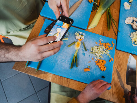 Friends enjoy creative cooking class composing vegetable figurine