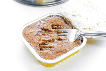 Pate cat wet food with a fork on the table.