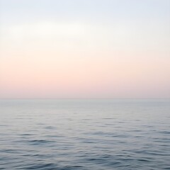 Obraz premium Serene Horizon Over Calm Ocean Waters with Soft Pastel Sky at Dawn or Dusk