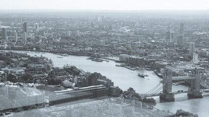Misty monochrome aerial London with skyline and Thames river.