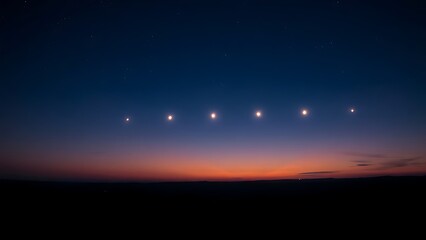 Fototapeta premium Six bright points of light aligned in the twilight sky above a dark, silhouetted horizon.