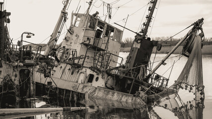 sunken and broken ships in a destroyed port in Ukraine during the war