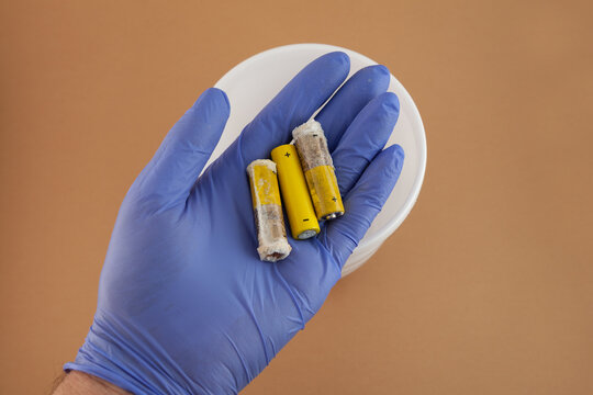 Old used alkaline batteries AA. Oxidized and leaked batteries, leakage of alkaline electrolyte. Concept of Separate collection of garbage and electronic waste