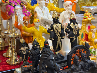a collection of Hindu deity statues, likely for sale, that are commonly found in and around temples in India.