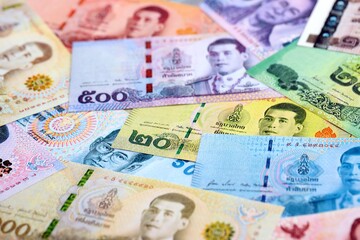Thai baht currency money bills. The current banknotes lies on table in big amount close up