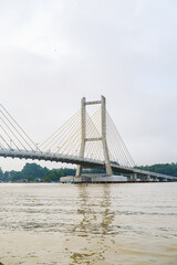 Cable-stayed bridge spanning across Kendari Bay, showcasing modern engineering and elegant design that connects the city’s shores with scenic reflection on calm waters.