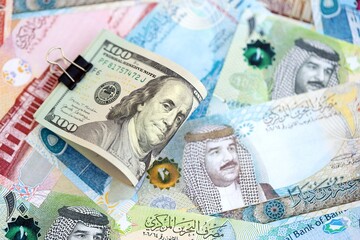 Bahraini dinar currency money bills and bunch of us dollar banknotes close up. The concept of economics and currency exchange