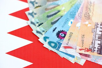 Bahraini dinar currency money bills lies on flag close up. The concept of business and investment