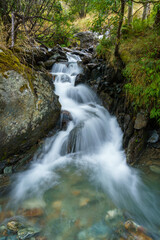 Gentle waterfall cascades over mossy rocks