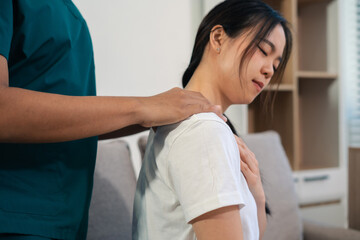 woman doing exercise at clinic with physiotherapist. help of a therapist trainer during a...