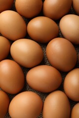 Many raw chicken eggs on table, above view